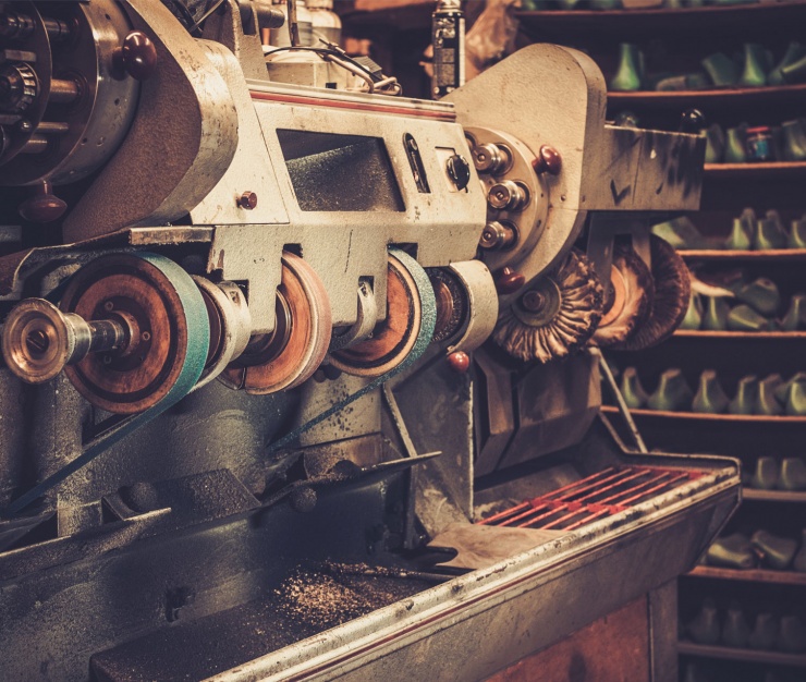 Close-up of a vintage industrial polishing or sanding machine in a workshop
