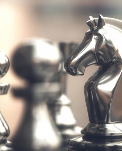 Metal chess pieces on a board, representing strategic legal advice in competition law, including cartel investigations, mergers, and regulatory compliance by SWVG Inc.
