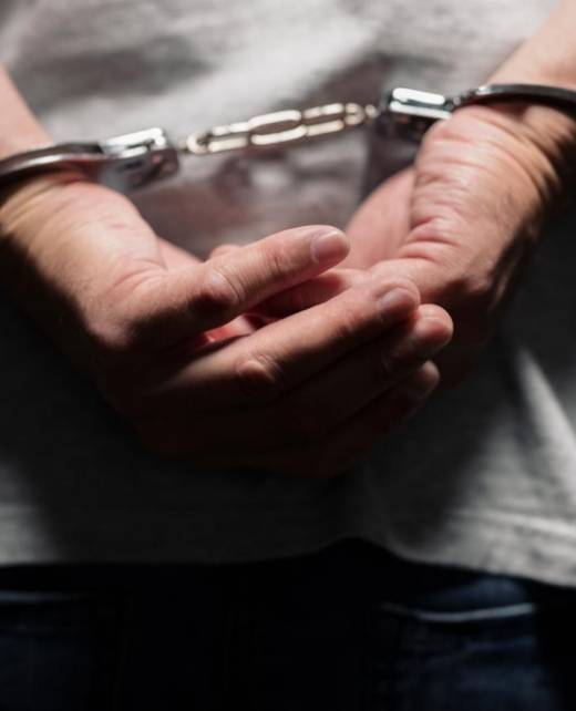 Close-up of a person in handcuffs, representing urgent legal defence and criminal law expertise at SWVG Inc.