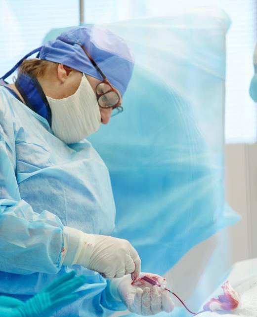 Surgeon in an operating theatre performing a complex procedure, symbolising the high-stakes nature of medical malpractice cases handled by SWVG Inc.