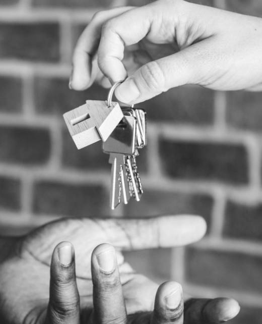 Person handing over a set of house keys, symbolising property transactions, lease agreements, and eviction services by SWVG Inc.