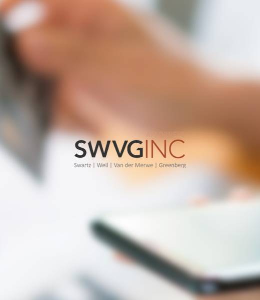 Hand holding a credit card above a smartphone, illustrating legal debt recovery and enforcement services.