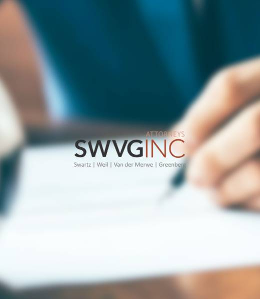 Close-up of a person signing a sports contract with a blurred football in view, symbolising SWVG Inc’s expertise in Sports and Entertainment Law.